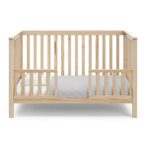 natural crib in toddler bed with two toddler safety guardrails