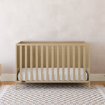 Theo driftwood crib in a nursery