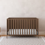 Theo hazelnut crib in a nursery