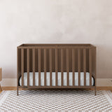 Theo hazelnut crib in a nursery