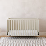 Theo frosted oat crib in a nursery