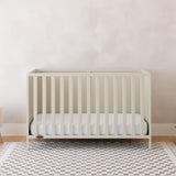 Theo frosted oat crib in a nursery