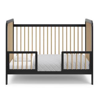 Black with driftwood crib in toddler bed conversion with two guardrails