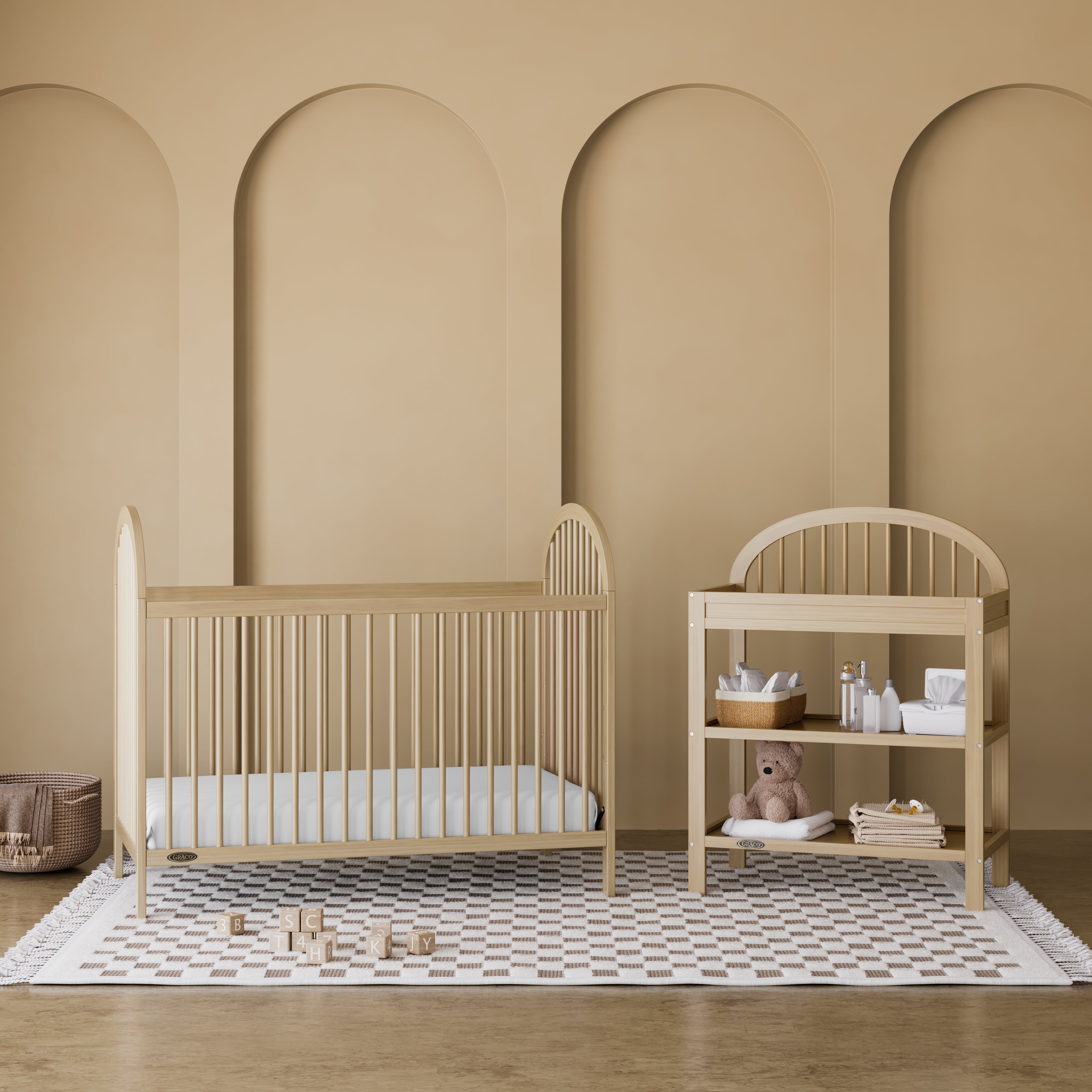 Olivia driftwood changing table in a nursery next to crib