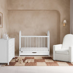 Olivia white crib with drawer in a nursery