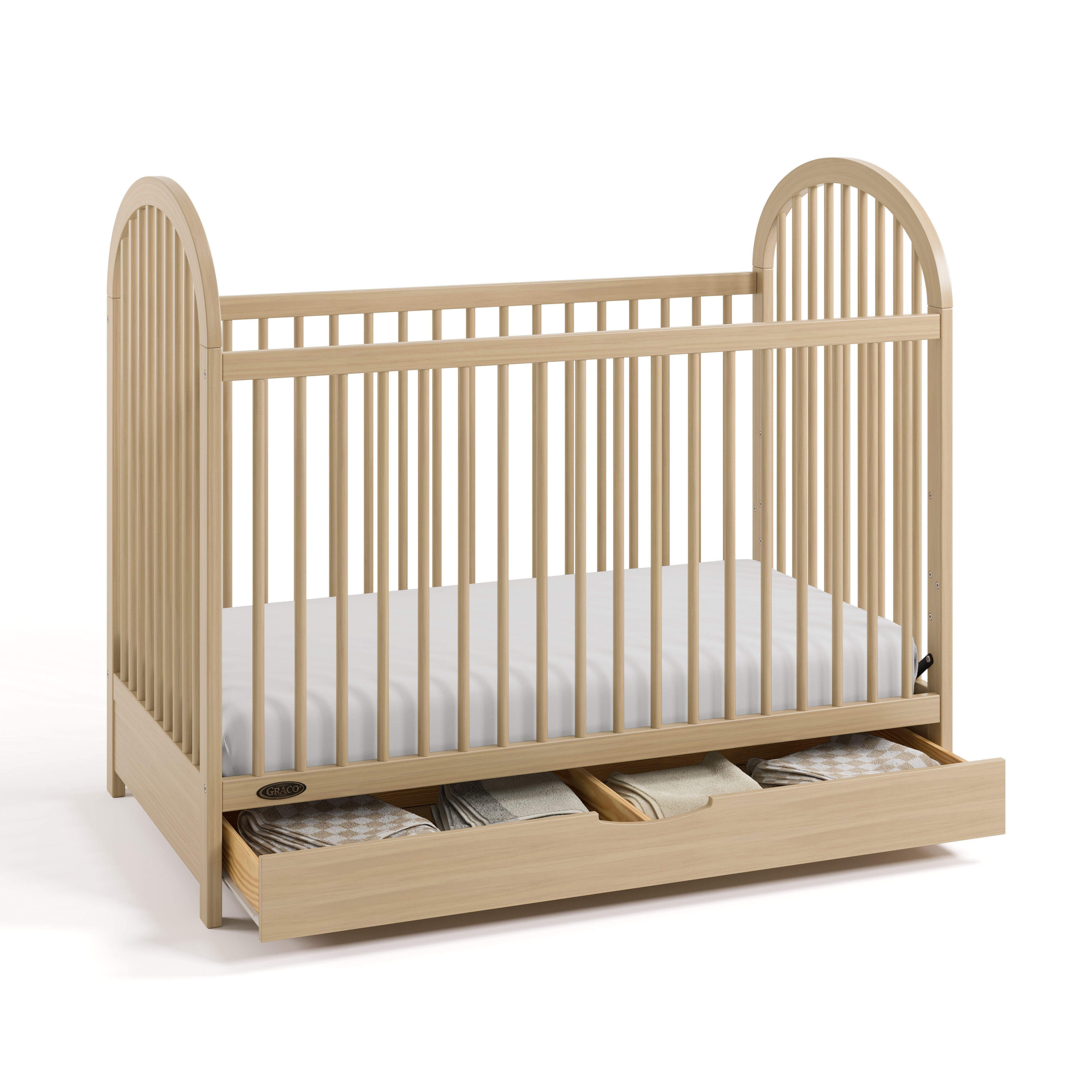 Olivia driftwood crib with drawer open and bedding inside angle view