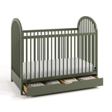 Olivia olive crib with drawer open and bedding inside angle view