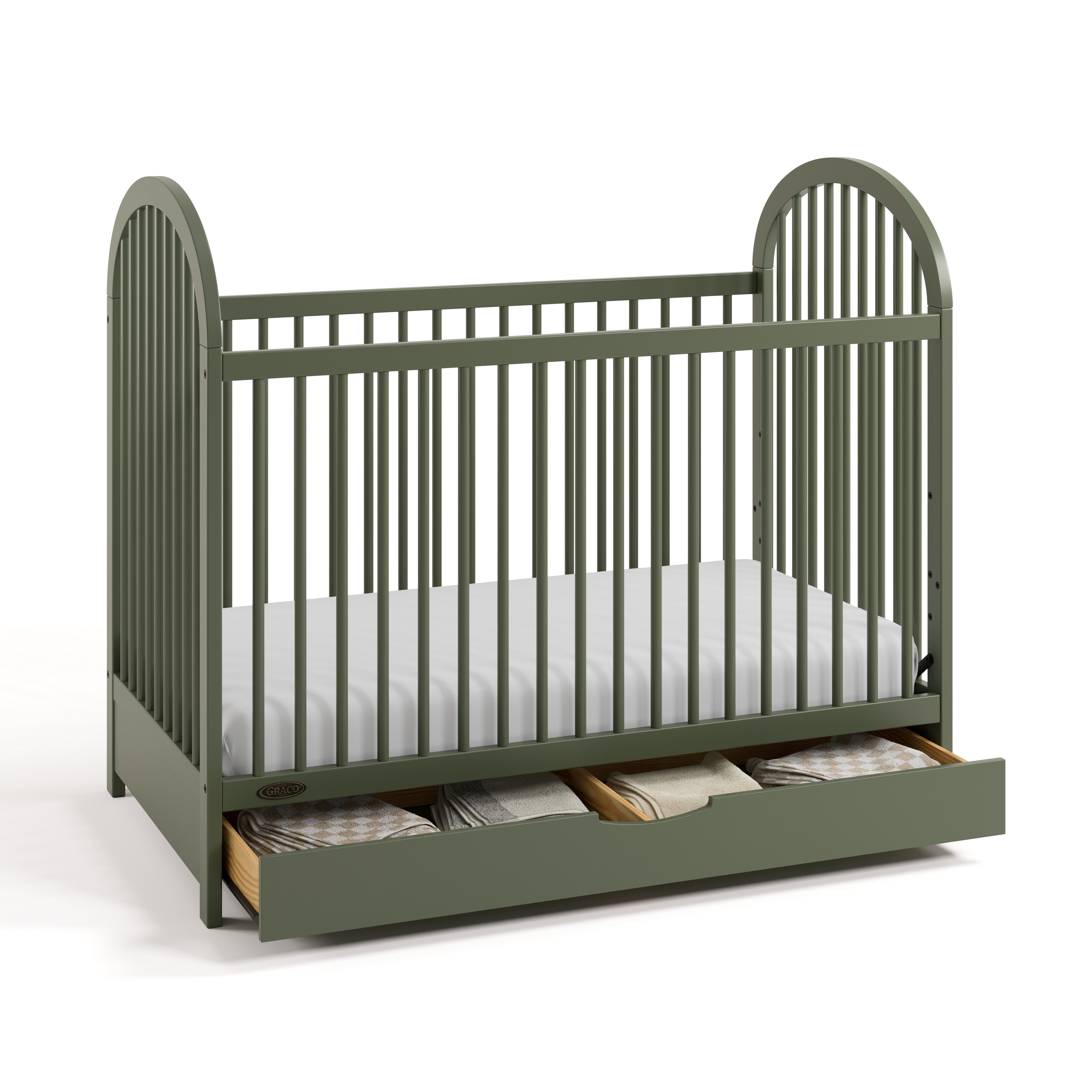 Olivia olive crib with drawer open and bedding inside angle view