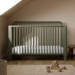 Porto olive crib in a nursery