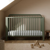 Porto olive crib in a nursery