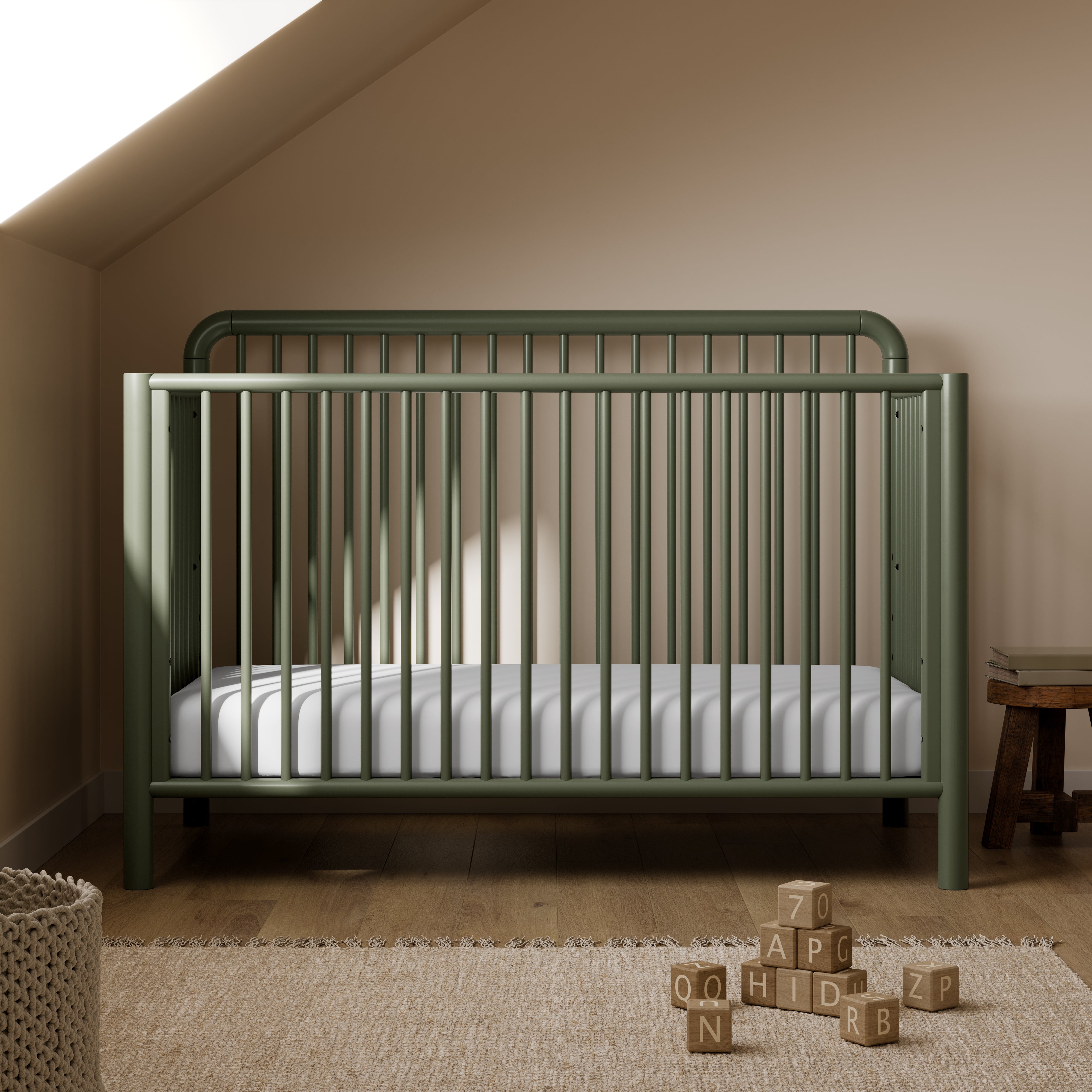 Porto olive crib in a nursery