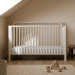 Porto frosted oat crib in a nursery