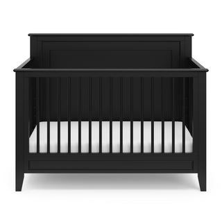 black crib with dowels and solid headboard