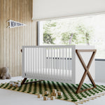 Equinox white with hazelnut crib in a nursery