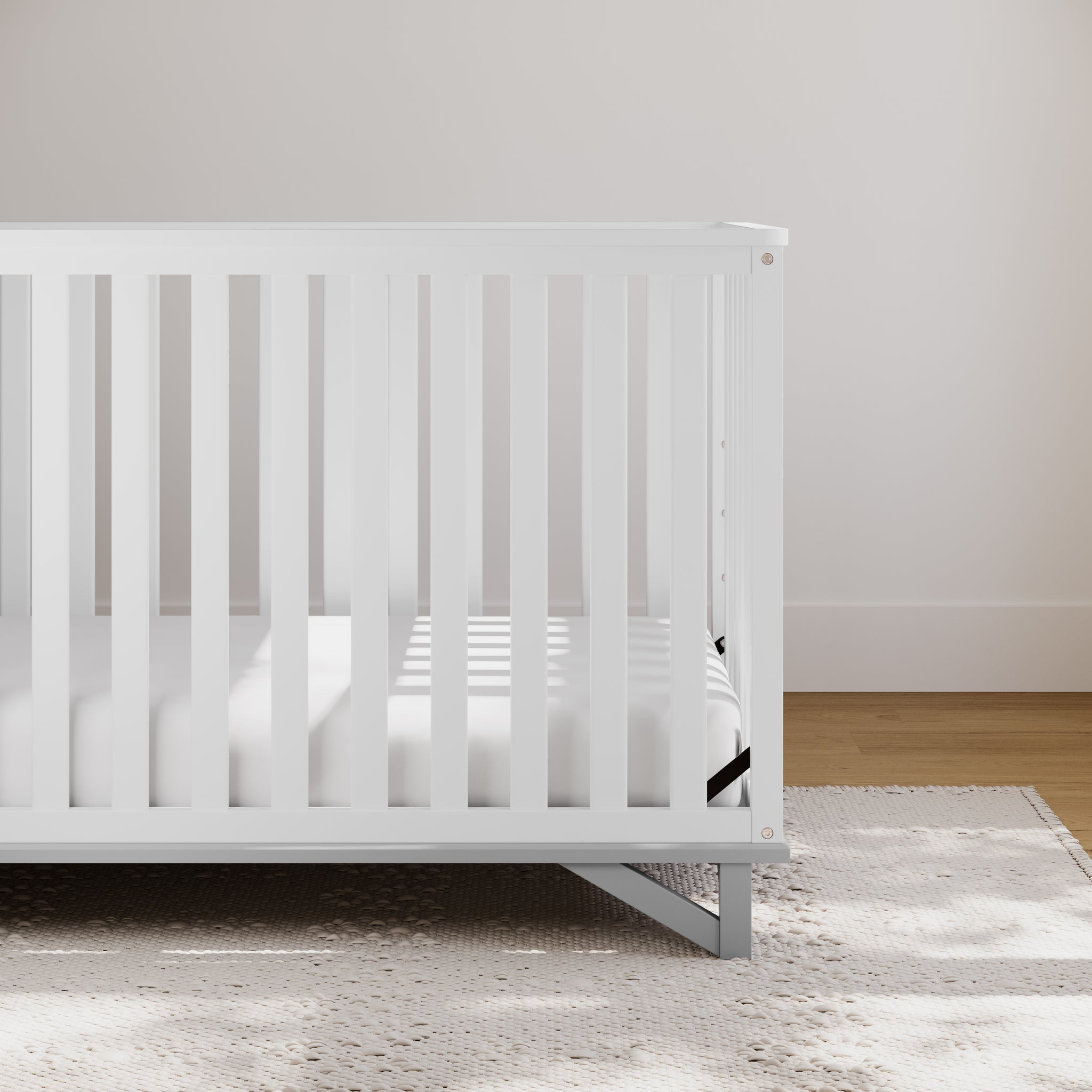 white with pebble gray crib in nursery