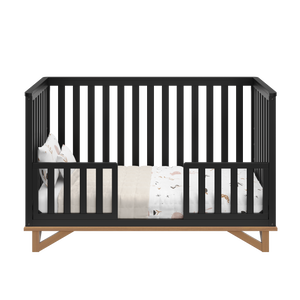 black with vintage driftwood crib in toddler bed conversion with two toddler safety guardrails