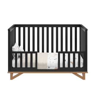 black with vintage driftwood crib in toddler bed conversion with two toddler safety guardrails