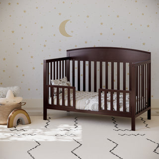 espresso crib in toddler bed conversion with 2 toddler safety guardrails, in nursery
