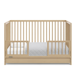 Driftwood crib with drawer in toddler bed conversion with two safety guardrails