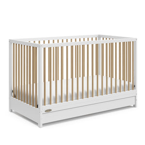 Angled view of white with driftwood crib