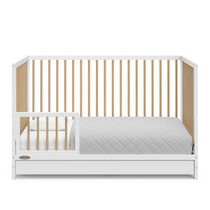 White with driftwood crib with drawer in toddler bed conversion with one safety guardrail