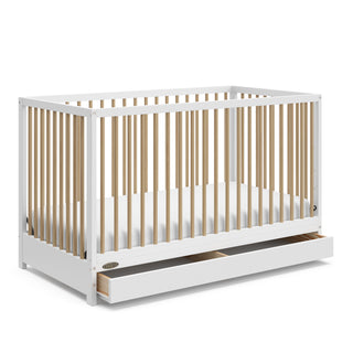 White with Driftwood crib with open drawer angled