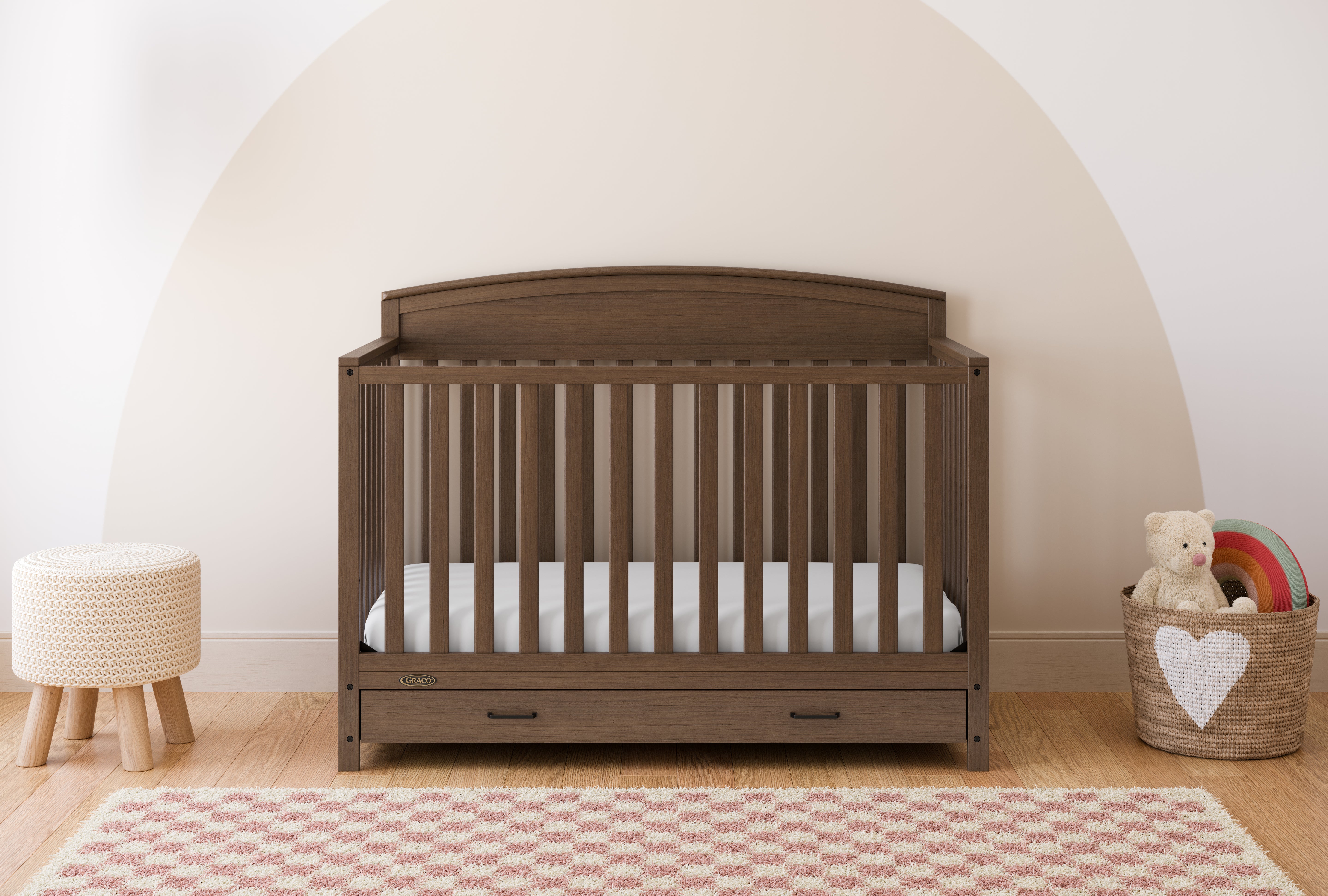 Benton hazelnut crib with drawer in a nursery