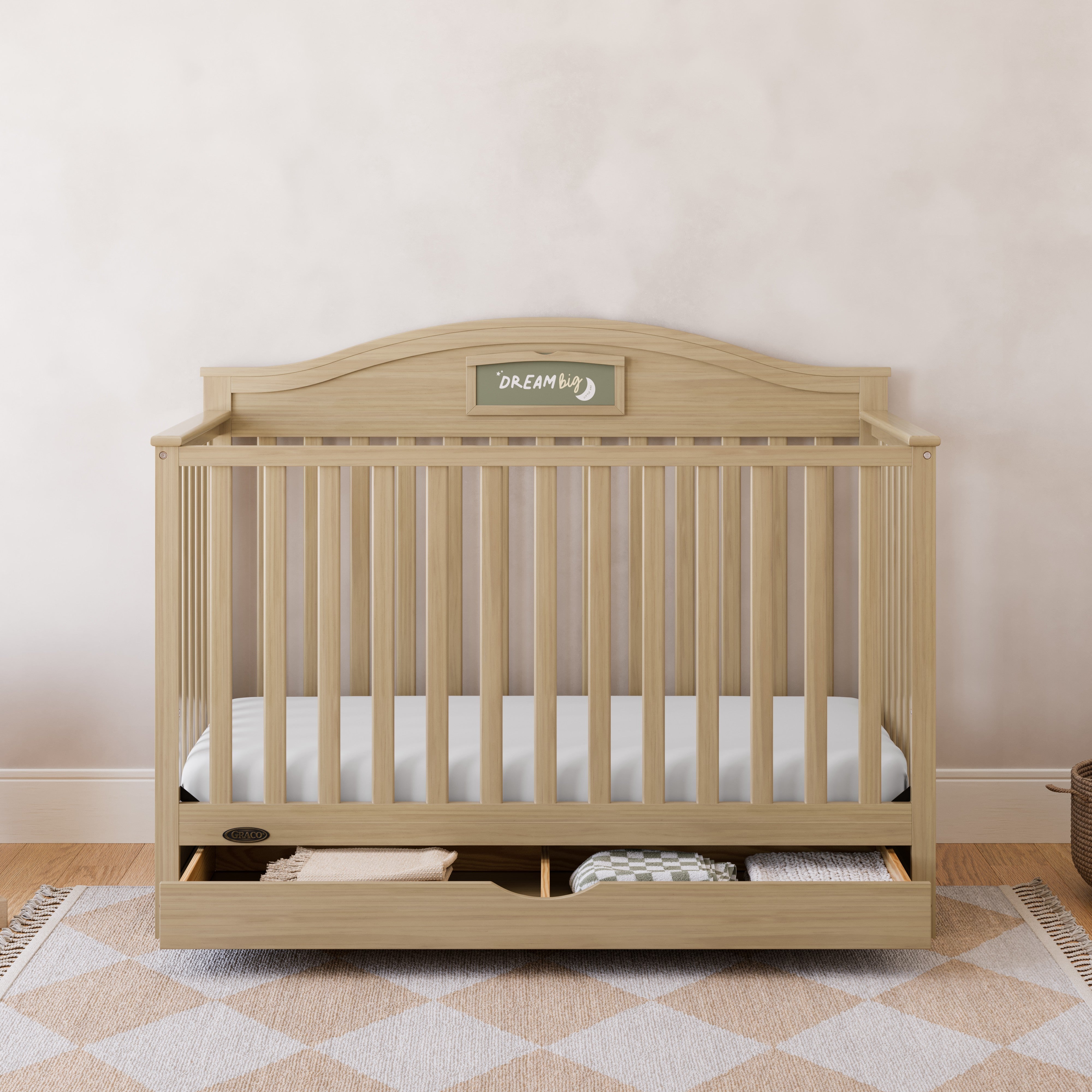 Story driftwood crib with drawer in a nursery