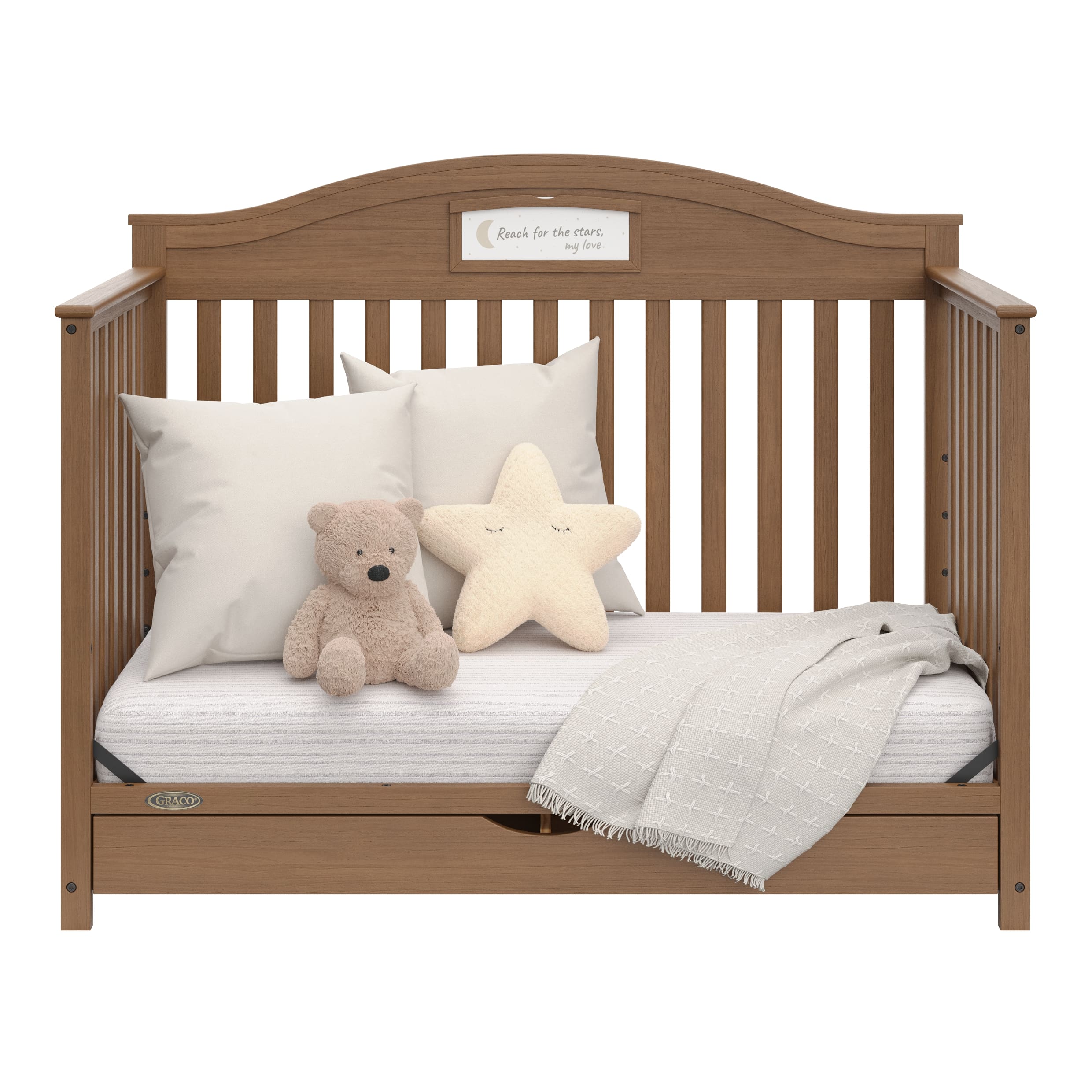 story hazelnut crib with drawer daybed conversion with pillows and blanket