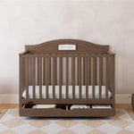 Story hazelnut crib with drawer in a nursery