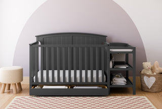 Gray crib and changer in nursery