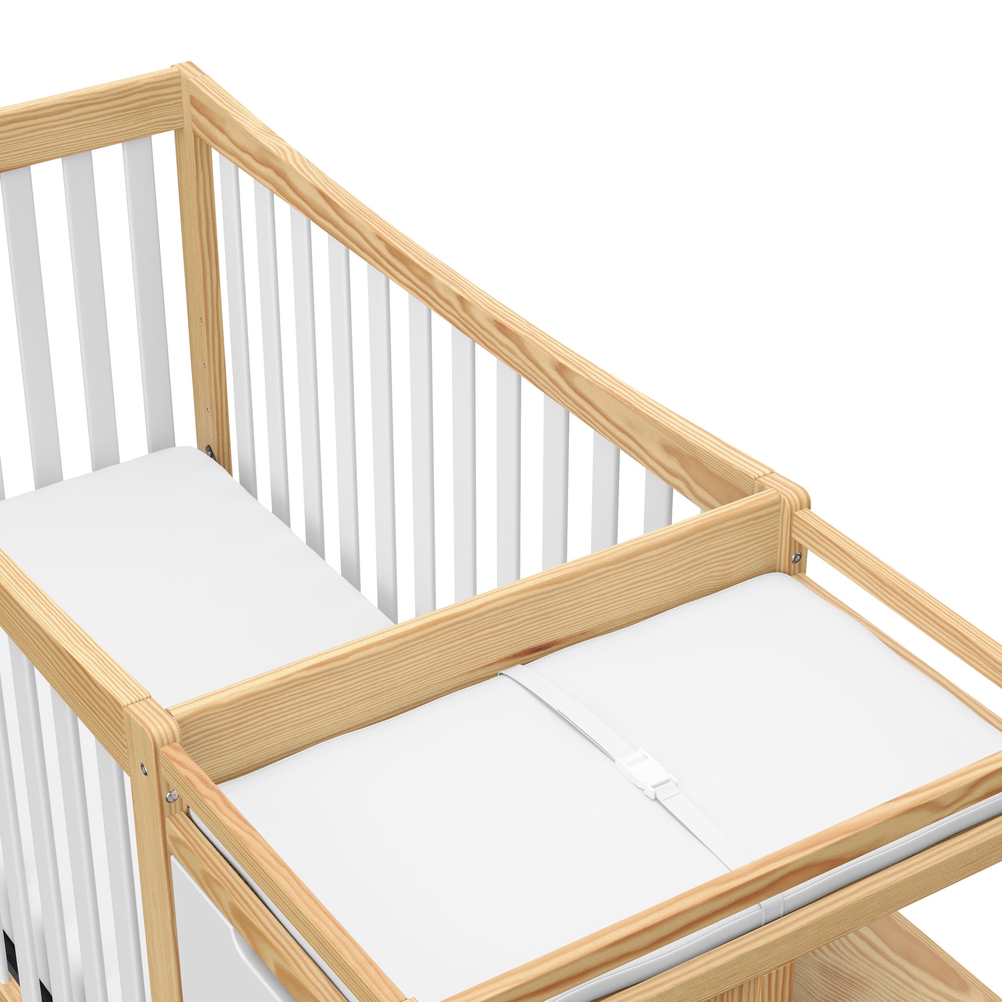 close-up view of white with natural crib with drawer and changer