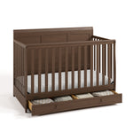Asheville hazelnut crib with drawer open and blankets inside angle view