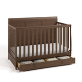 Asheville hazelnut crib with drawer open and blankets inside angle view