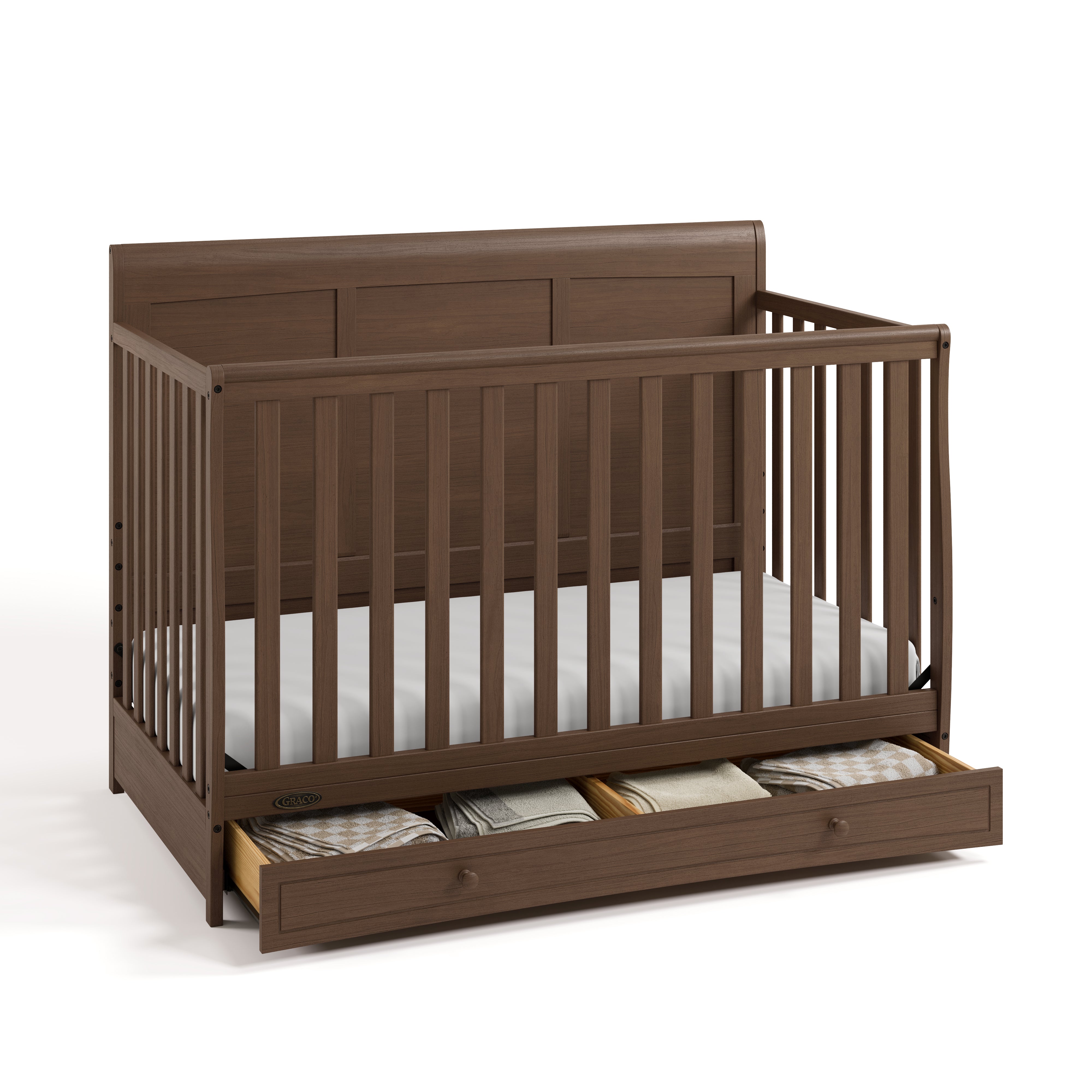 Asheville hazelnut crib with drawer open and blankets inside angle view