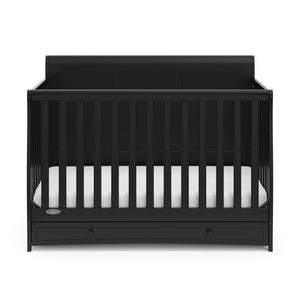 Front view of black crib with drawer