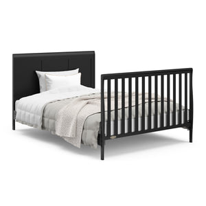 Black crib with drawer in full-size bed conversion with headboard and footboard