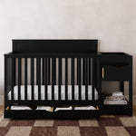 Shiloh black crib and changer with drawers open in nursery