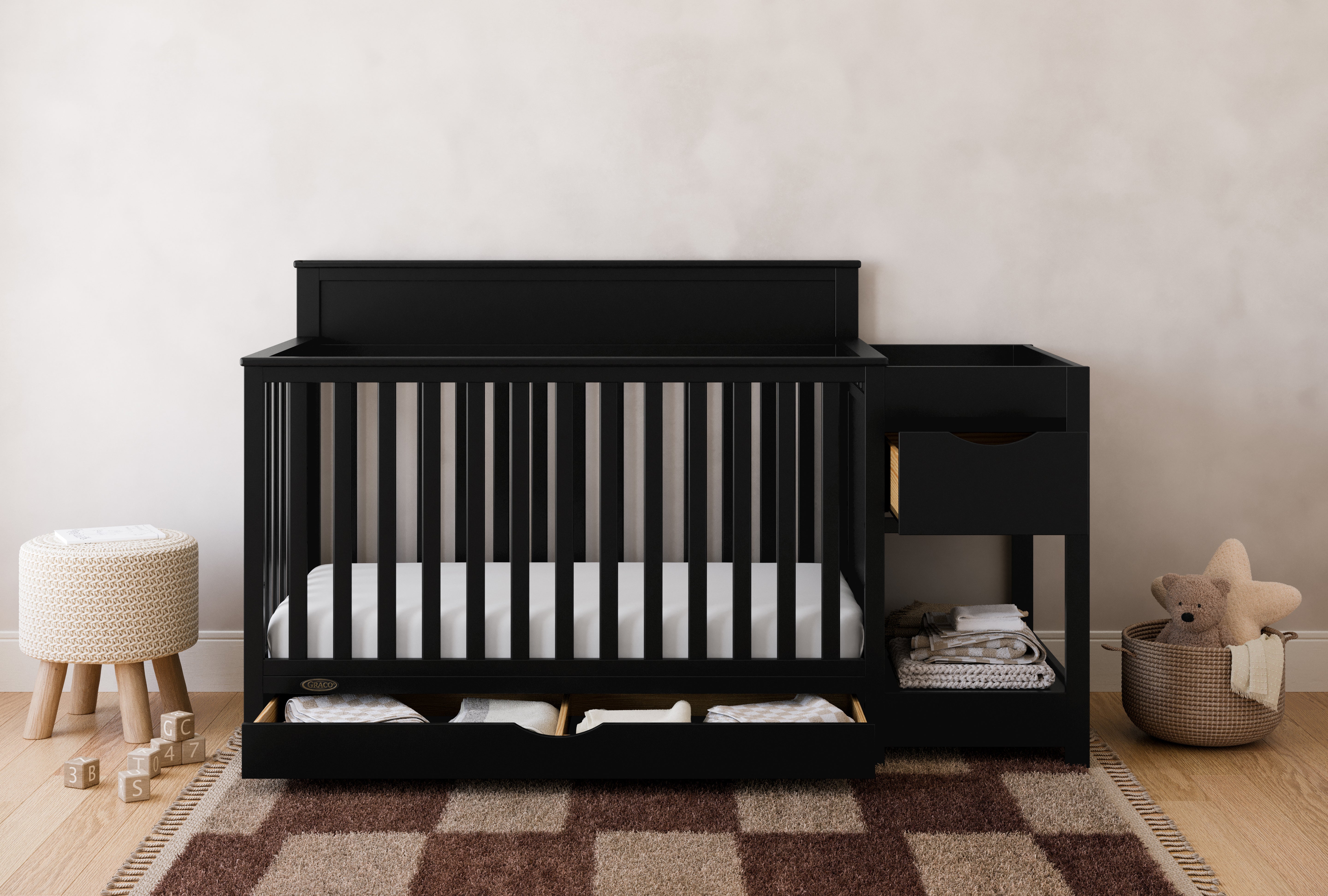Shiloh black crib and changer with drawers open in nursery