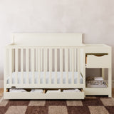 Shiloh frosted oat crib and changer with drawers open in nursery