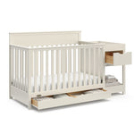 Shiloh frosted oat crib and changer with drawers open angle view