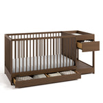 Teddi hazelnut crib and changer angle view with baby items in drawers