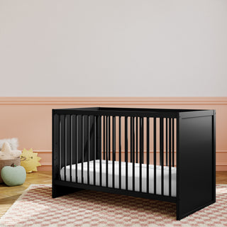 angled black crib in nursery