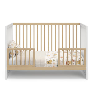 white with driftwood crib in toddler conversion with two toddler safety guardrails