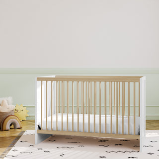 white with driftwood crib in nursery