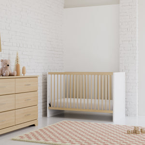 White with driftwood finishes crib, and driftwood 6-drawer dresser in a beautifully furnished room