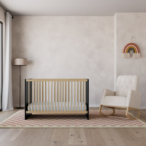 black with vintage driftwood crib with glider in nursery