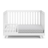 Beckett white crib converted to toddler bed with one guardrail