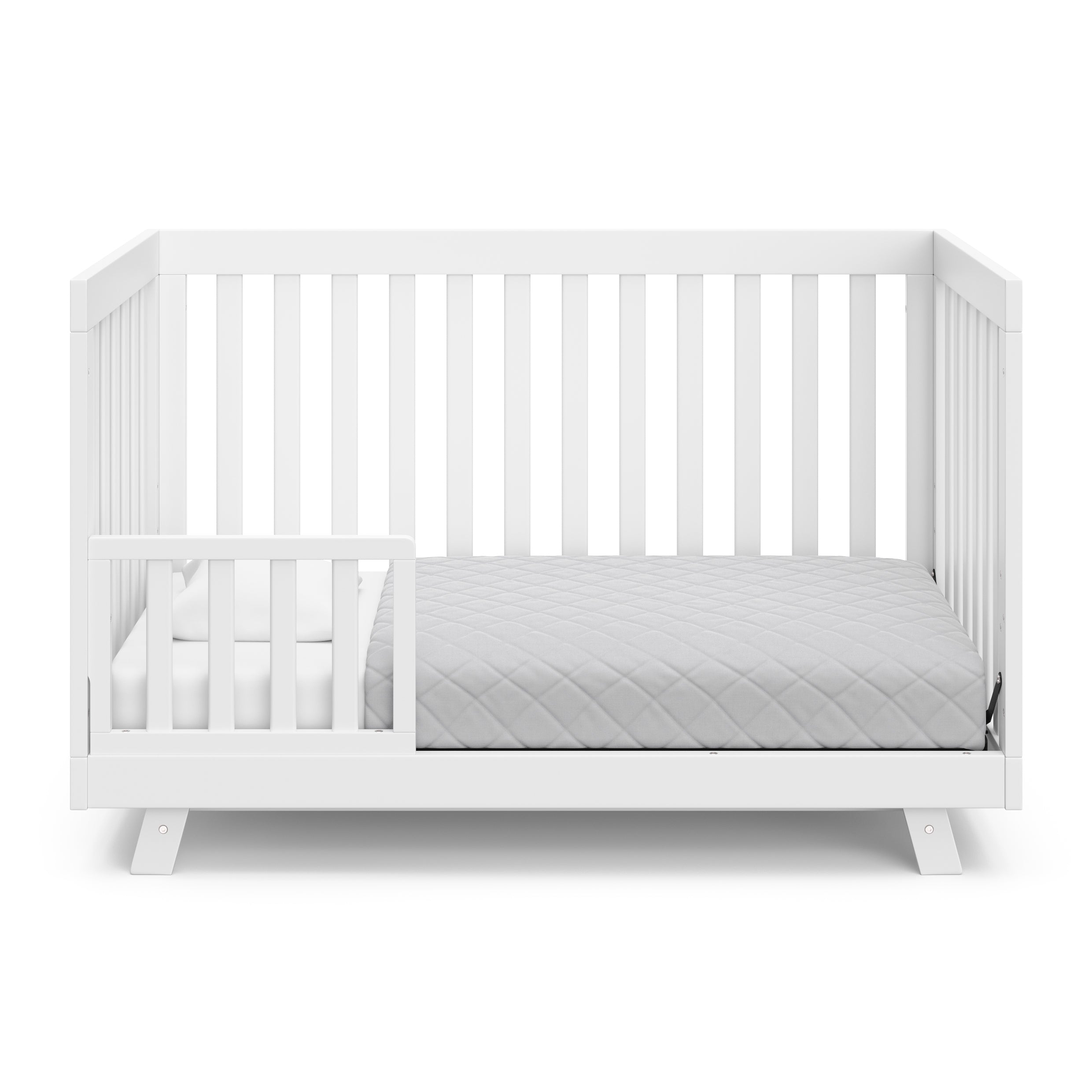 Beckett white crib converted to toddler bed with one guardrail