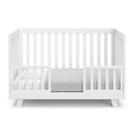 Beckett white crib converted to toddler bed with two guardrails